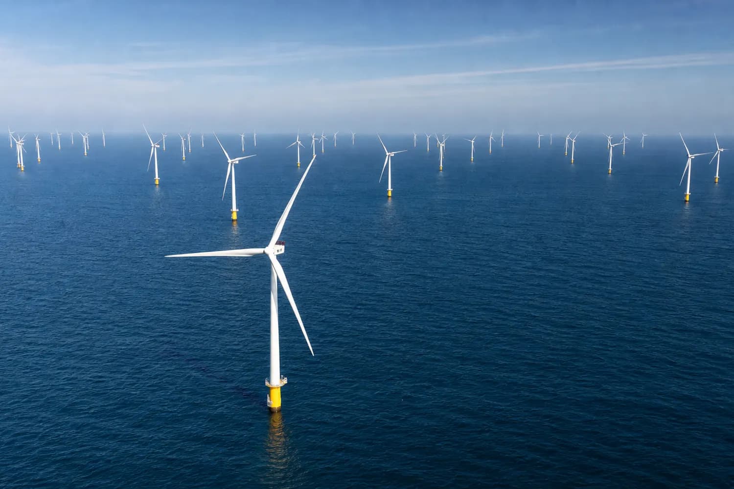 Aerial view of offshore wind turbines at sea.